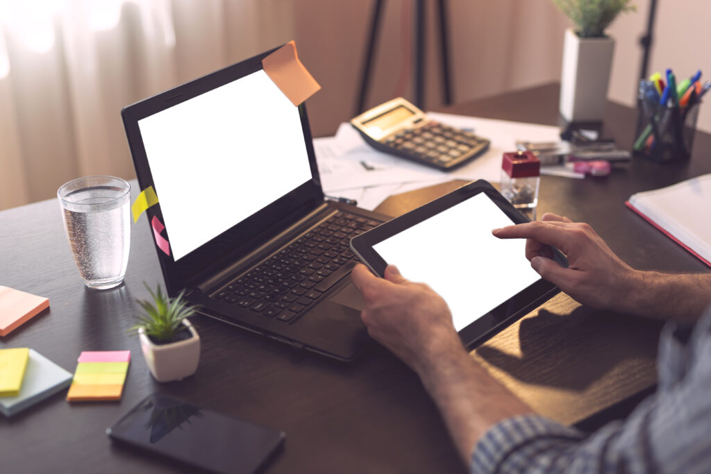 Businessman using laptop and a smart phone